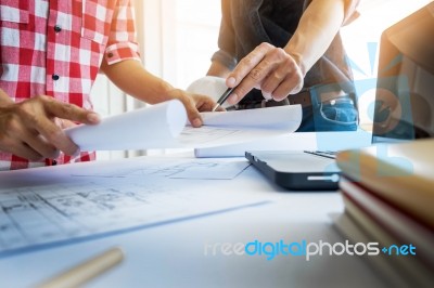 Architects Engineer Discussing At The Table With Blueprint - Clo… Stock Photo