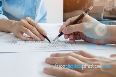 Architects Engineer Discussing At The Table With Blueprint - Clo… Stock Photo