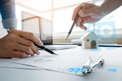 Architects Engineer Discussing At The Table With Blueprint - Clo… Stock Photo