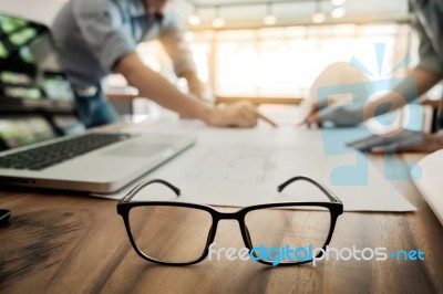 Architects Engineer Discussing At The Table With Blueprint - Clo… Stock Photo