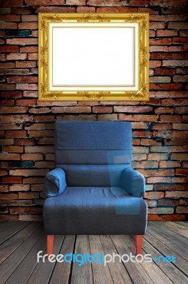 Arm Chair With Frame On Wall Stock Photo