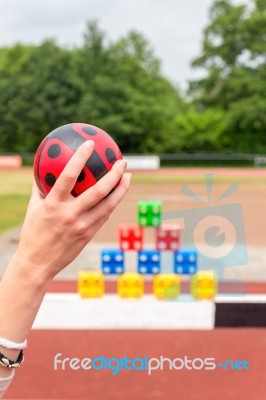 Arm With Ball To Throw Off Colored Blocks Stock Photo