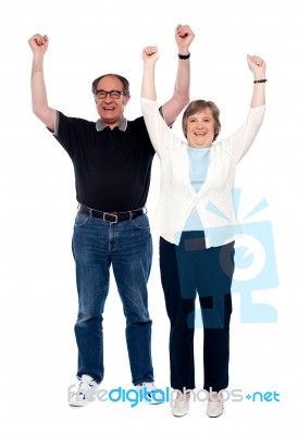 Arms Raised Aged Couple Stock Photo