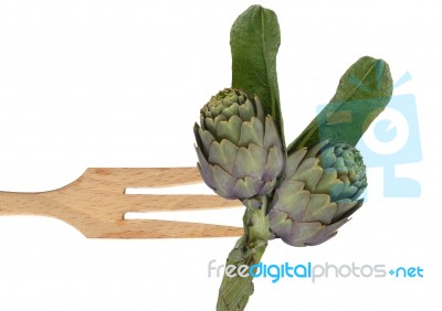 Artichokes on fork Stock Photo