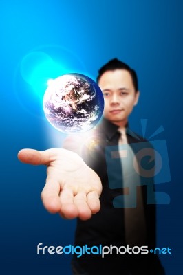 Asia Business Man Holding Globe Stock Photo