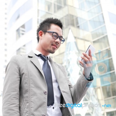 Asia Business Man Using A Mobile Phone Stock Photo