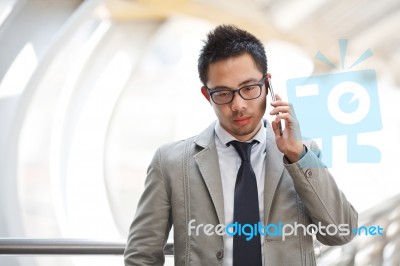 Asia Business Man Using A Mobile Phone Stock Photo