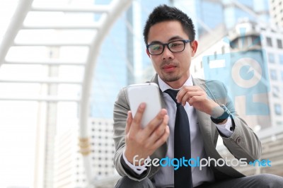 Asia Business Man Using A Mobile Phone Stock Photo