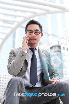 Asia Business Man Using A Mobile Phone Stock Photo