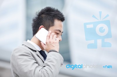 Asia Business Man Using A Mobile Phone With Copyspace Stock Photo