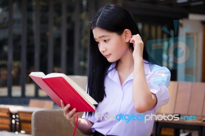 Asia Thai High School Student Uniform Beautiful Girl Read A Book… Stock Photo