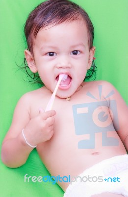 Asian Baby And Toothbrush Stock Photo