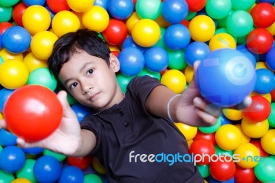 Asian Boy And Colorful Small Ball Stock Photo