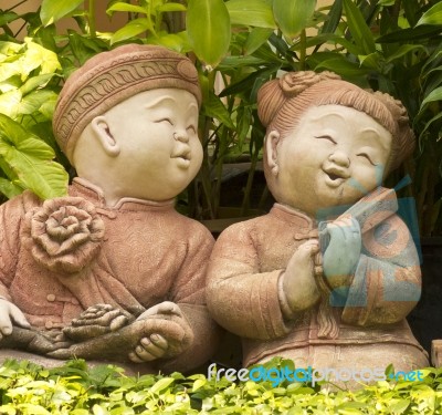 Asian Boy And Girl Statues Stock Photo