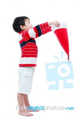 Asian Boy Hold Santa Hat Looking Upwards Stock Photo