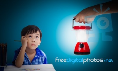 Asian Boy Thinking And Looking Up, Hand Holding Plastic Electric… Stock Photo