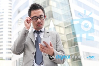 Asian Business Man Speaking Mobile Phone Stock Photo