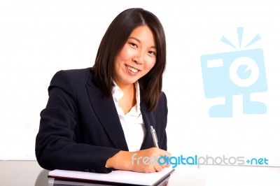 Asian Businesswoman Writing Stock Photo