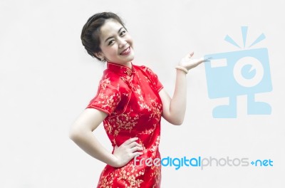 Asian Chinese Woman In Traditional Chinese Cheongsam Gesturing Stock Photo