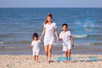 Asian Family On Beach Stock Photo