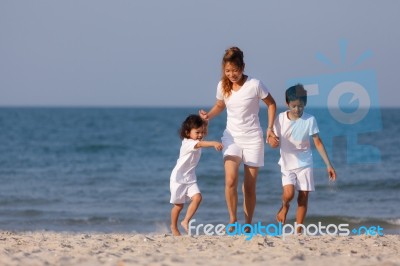 Asian Family On Beach Stock Photo