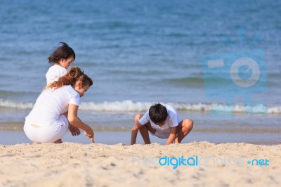 Asian Family On Beach Stock Photo