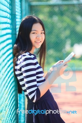 Asian Girl And Computer Tablet In Hand Standing With Toothy Smiling Face Use For People And Internet Connecting ,communication In Modern Digital Lifestyle Stock Photo