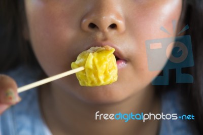 Asian Girl Eating Dumplings Stock Photo