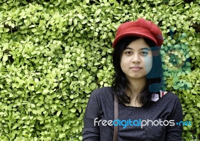 Asian Girl On A Background Of Green Nature Stock Photo