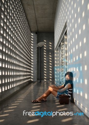 Asian Girl Sitting On Corridor Floor Stock Photo