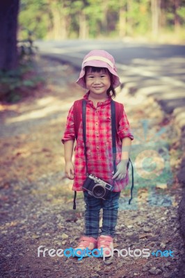 Asian Girl With Digital Camera In Beautiful Outdoor. Vintage Effect Tone Stock Photo