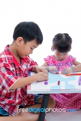 Asian Kids Playing With Play Clay On Table. Strengthen The Imagi… Stock Photo