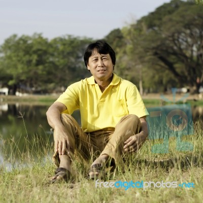 Asian Middle-aged Man In The Park Stock Photo