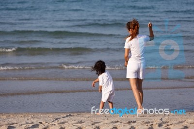 Asian Mom And Son On Beach Stock Photo