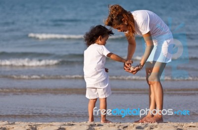 Asian Mom And Son On Beach Stock Photo