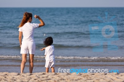 Asian Mom And Son On Beach Stock Photo