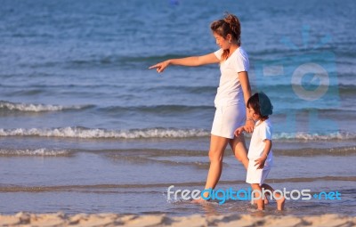 Asian Mom And Son On Beach Stock Photo