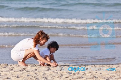 Asian Mom And Son On Beach Stock Photo