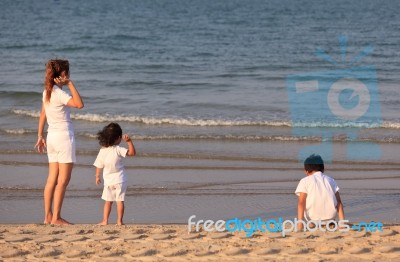 Asian Mom And Son On Beach Stock Photo