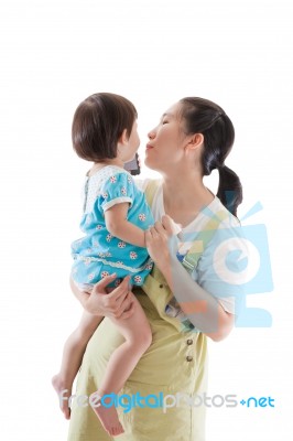 Asian Mother Carrying And Soothe Her Daughter On White Background Stock Photo