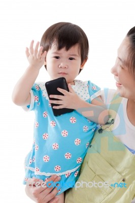 Asian Mother Carrying Her Daughter On White Background Stock Photo