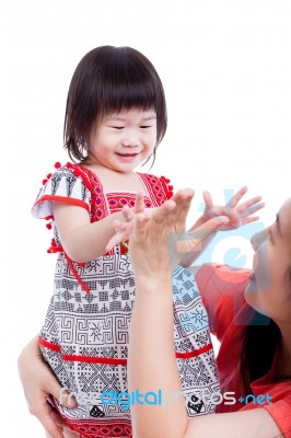 Asian Mother Playing Her Adorable Little Daughter, On White. Studio Shot Stock Photo