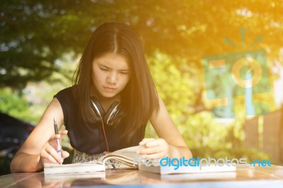 Asian Teen Student Reading Book Preparing For Exam  Stock Photo