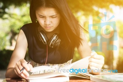 Asian Teen Student Reading Book Preparing For Exam  Stock Photo