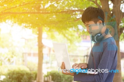 Asian Teenager Using Laptop  Stock Photo