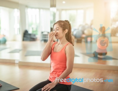 Asian Woman Doing Yoga Indoors Stock Photo