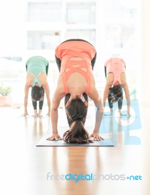 Asian Woman Doing Yoga Indoors Stock Photo