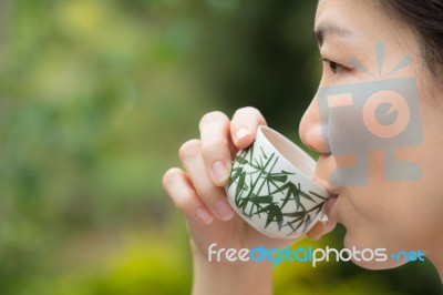 Asian Woman Drinking Tea Stock Photo