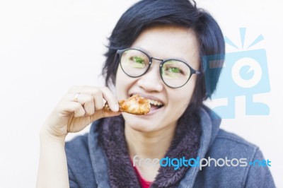 Asian Woman Eating Delicious Chicken Stock Photo