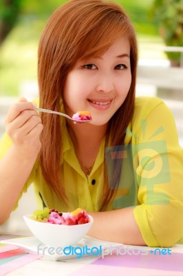 Asian Woman Eating Fruits Stock Photo